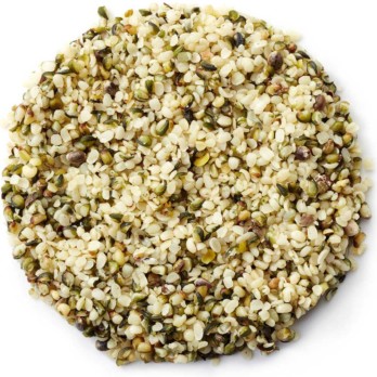Image shows a small circle of white and green hemp seeds on a white background