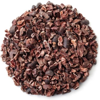 Image shows a small circle of dark brown cacao nibs on a white background