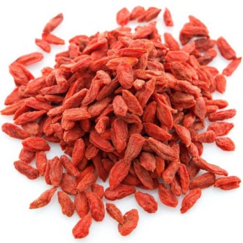 Image shows a small pile of long red goji berries on a white background