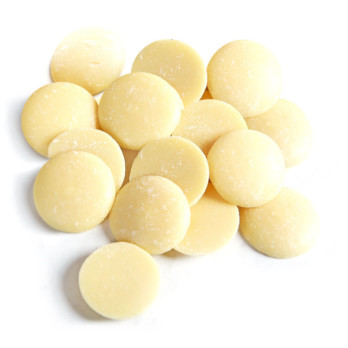 Image shows a small pile of cacao butter (cream coloured wafers) on a white background